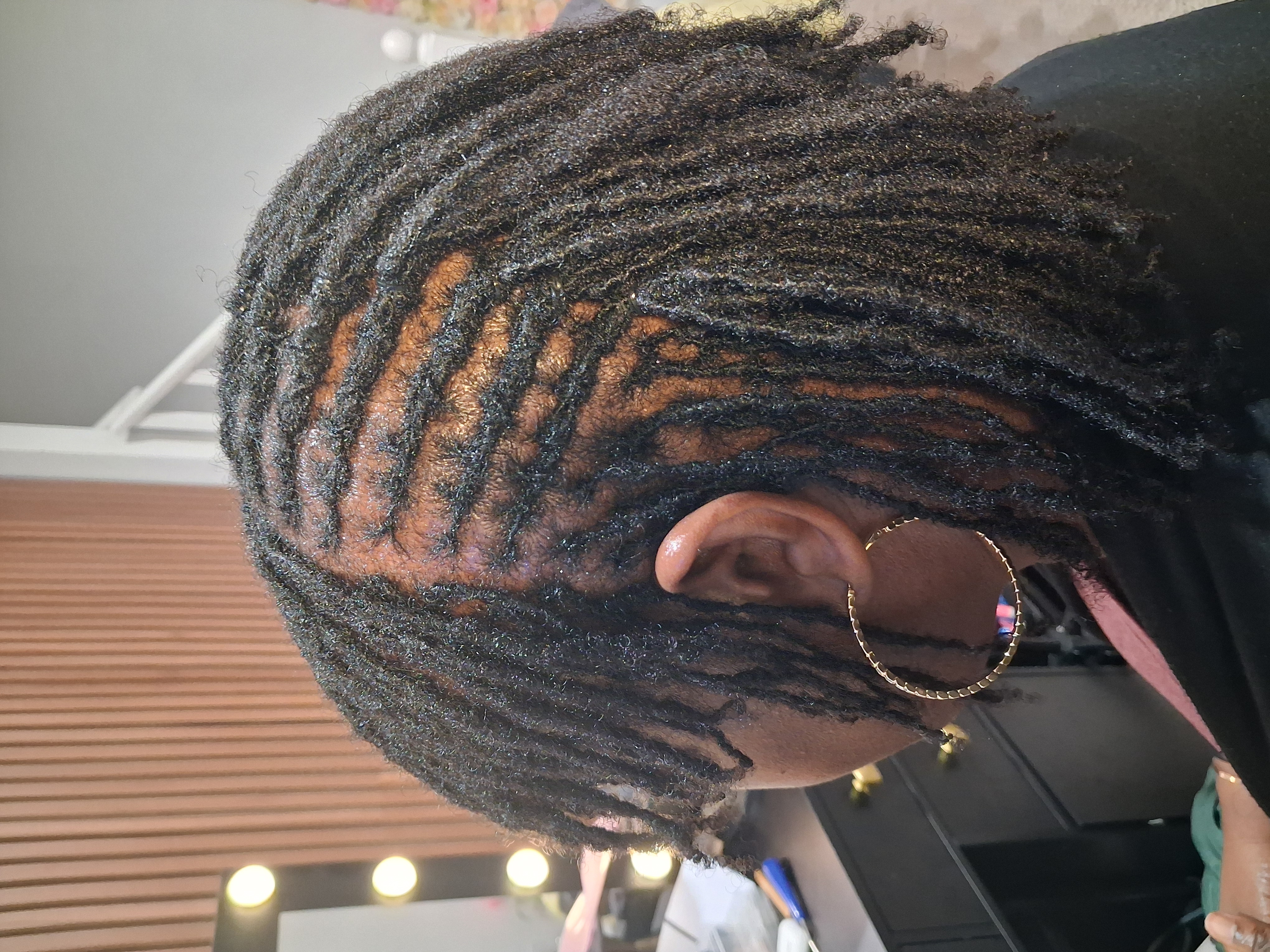 Freshly retwisted locs styled to the side