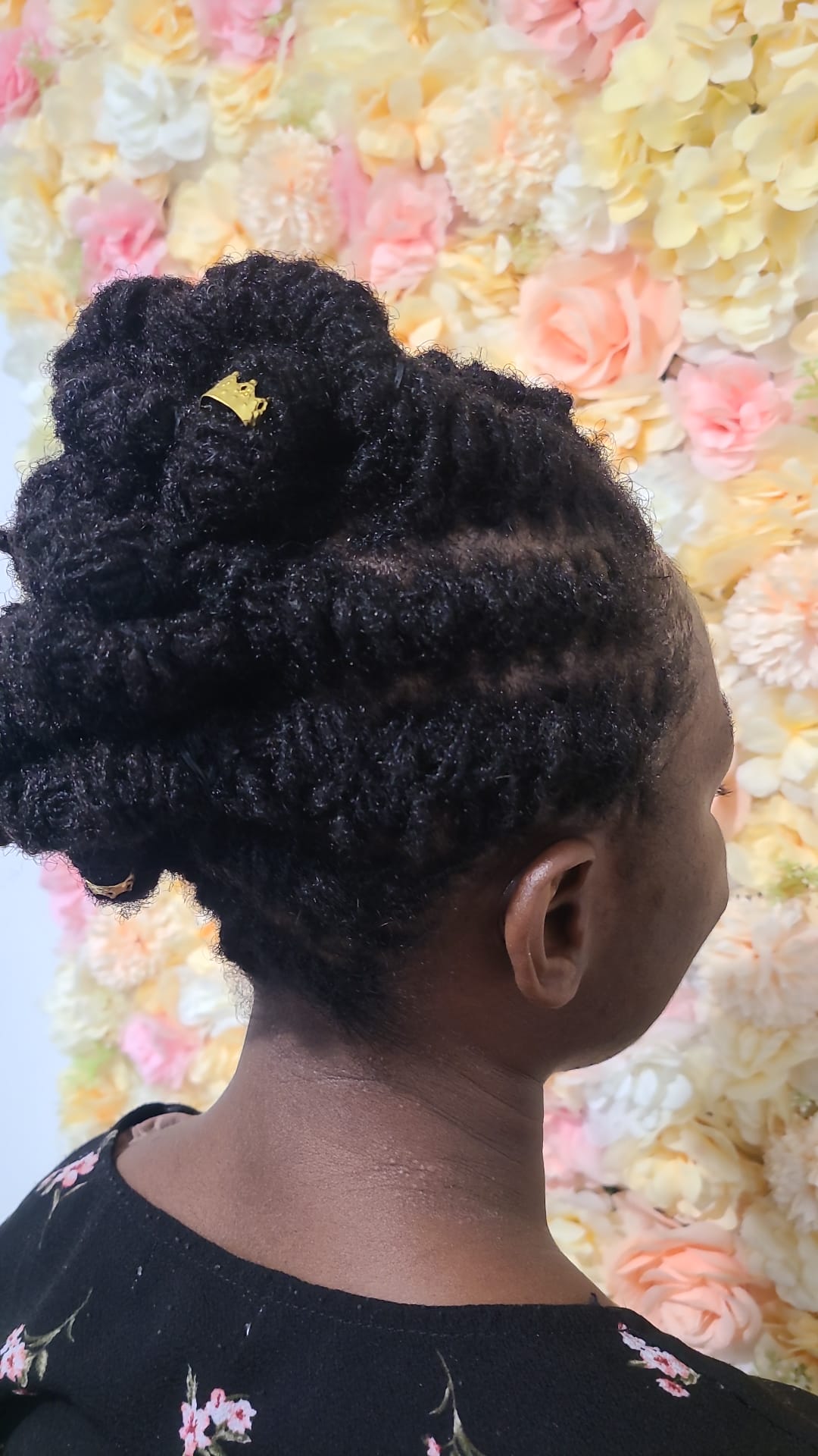 Sculpted loc bun finished with a gold crown cuff